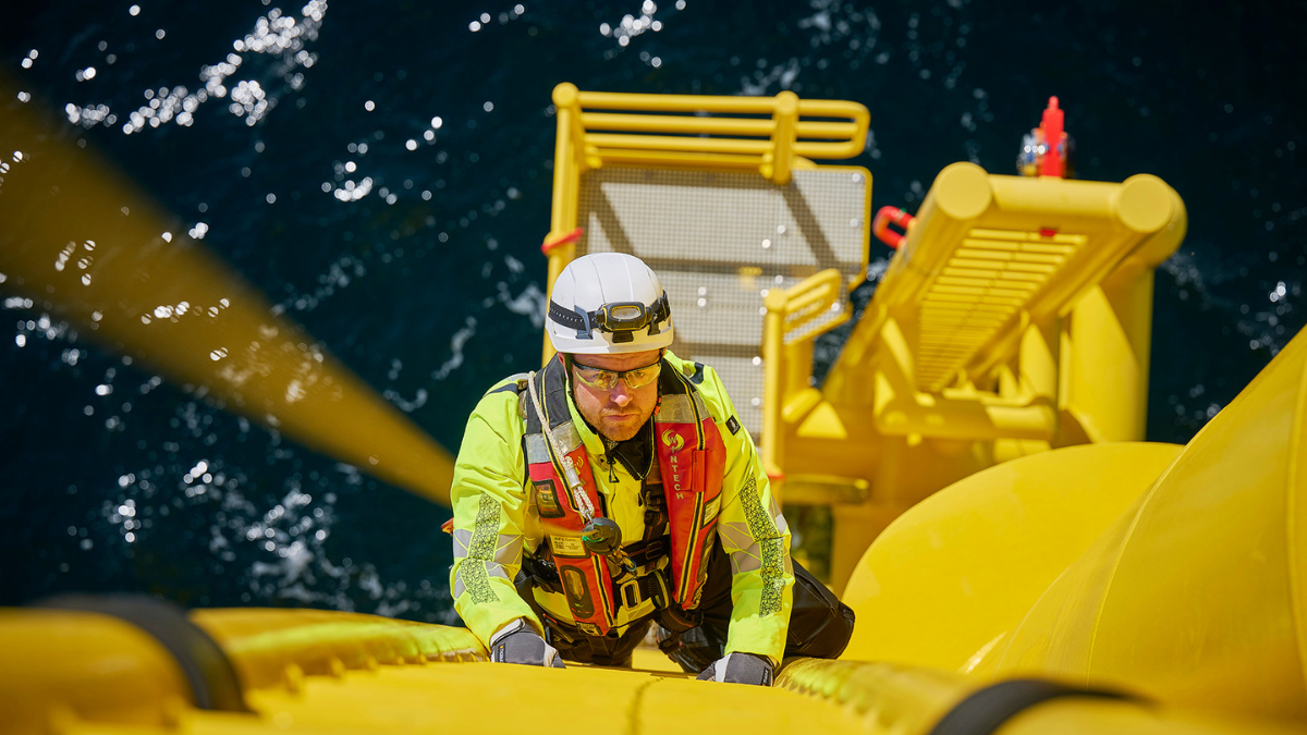 Technician climbing up a wind turbine